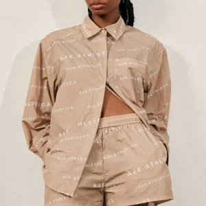 Shop Aje ATHLETICA All Over Logo Spray Shirt 406 Natural Tan / White