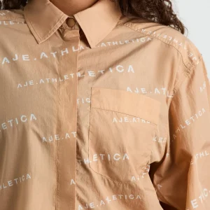 Shop Aje ATHLETICA All Over Logo Spray Shirt 406 Natural Tan / White