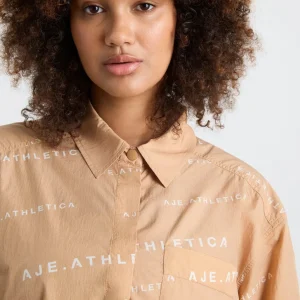 Shop Aje ATHLETICA All Over Logo Spray Shirt 406 Natural Tan / White