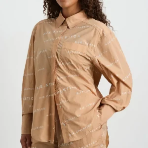 Shop Aje ATHLETICA All Over Logo Spray Shirt 406 Natural Tan / White