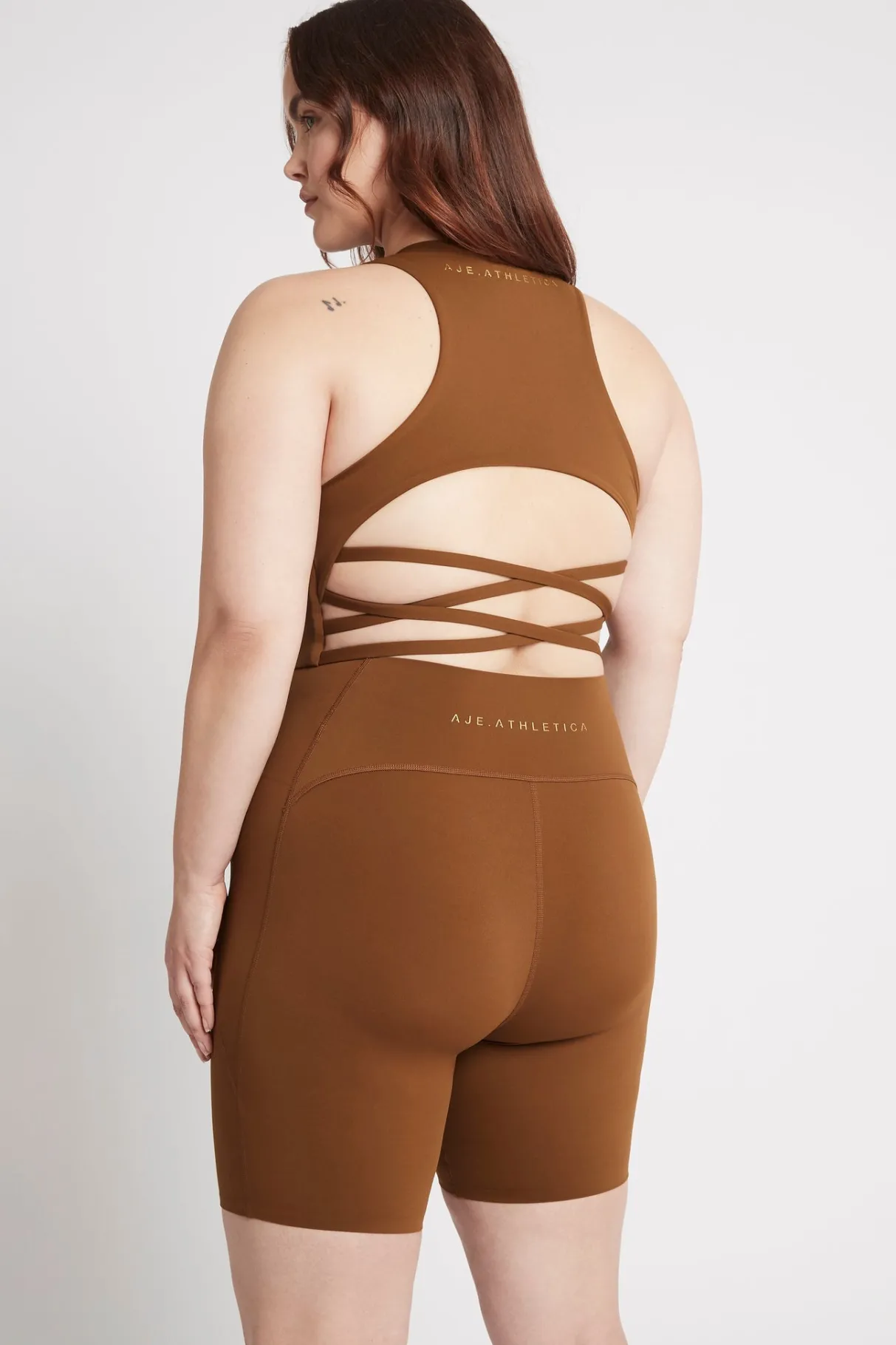 high_rise_mid_length_embossed_bike_short__13.webp Discount Aje ATHLETICA High Rise Mid Length Embossed Bike Short 615 Coffee/Gold