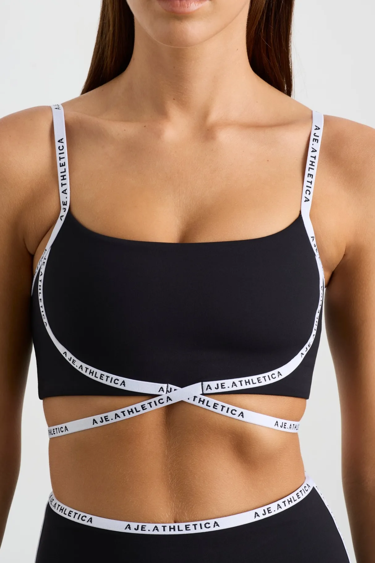 logo_tape_crossover_bra__3.webp Outlet Aje ATHLETICA Logo Tape Crossover Bra 393 Black/White