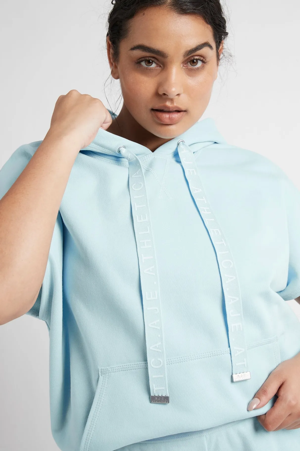 logotape_short_sleeve_hoodie__13.webp Online Aje ATHLETICA Logotape Short Sleeve Hoodie 403 Ice Blue