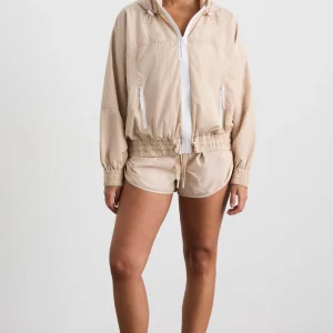 Shop Aje ATHLETICA Long Line Spray Jacket Latte Beige