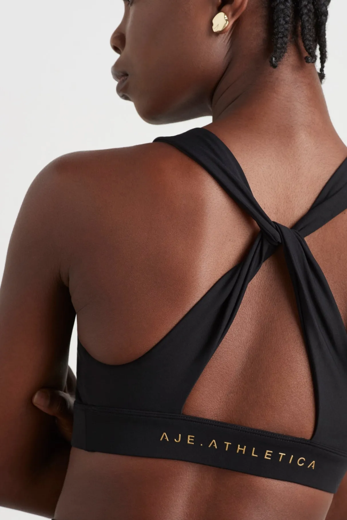 twist_back_sports_bra__0-1.webp Fashion Aje ATHLETICA Twist Back Sports Bra 335 Black/Gold